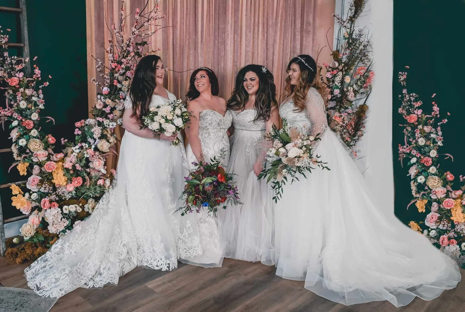 A bride in a lace gown holding her bouquet at The Flawless Bride